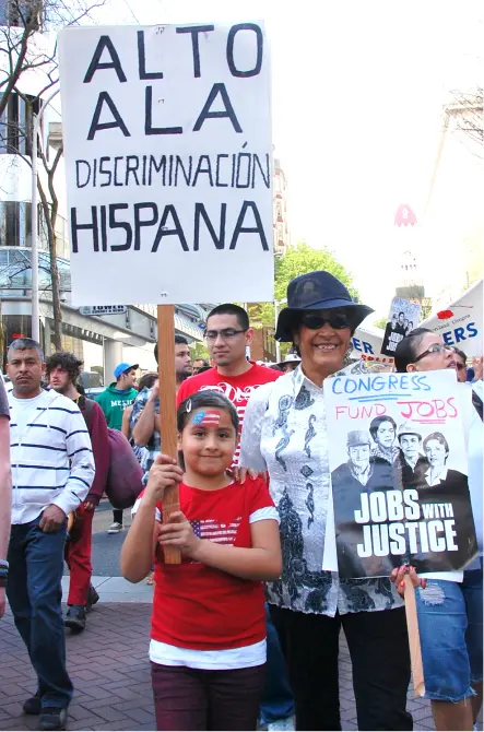 Child with sign and adult.